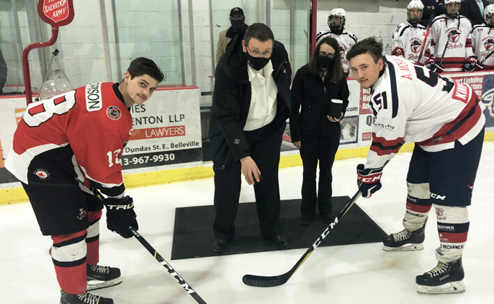 Picton Pirates Captain Devin Morrison and Campbellford Rebels counterpart Andrew Moran wait for Joseph and Donna Ludlow to drop the puck Thursday evening. (Photo: Gazette Staff)