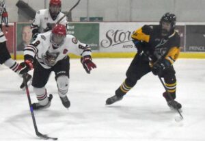 Rheydan McCoy battles for a loose puck with a poke.