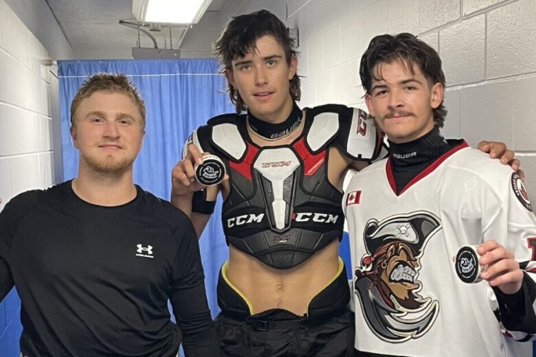 Trevor Brooks, Will Potts and Nolan Rosebush hold up their pucks after scoring their first goals as PIrates.